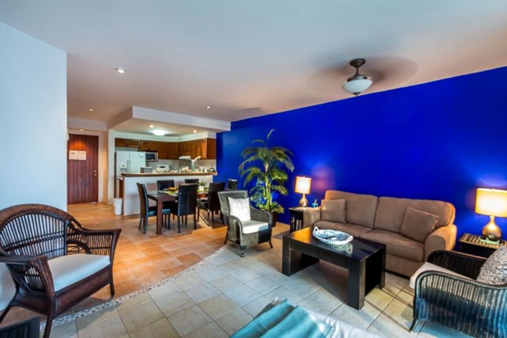 The bright and colorful living area has a comfy couch and bonus pullout sleeper sofa