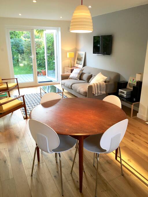 Living room and kitchen. Double doors lead out into the bright garden. Seating and bbq provided for the garden