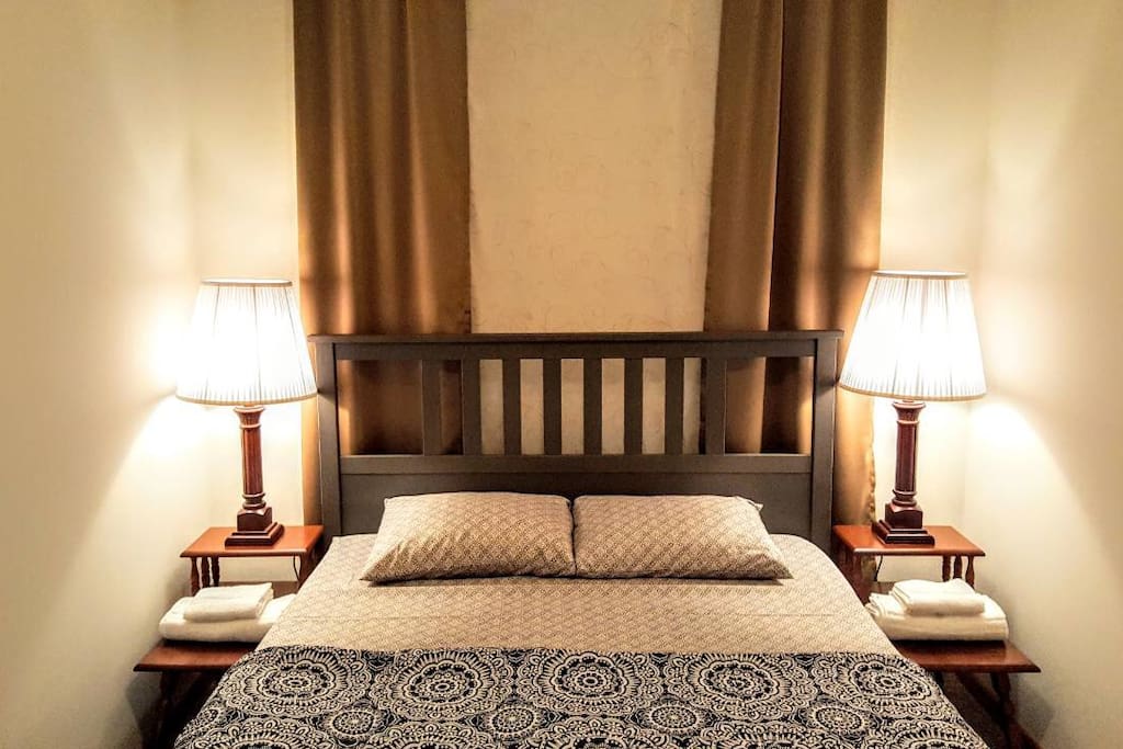 This is exactly how you will find your bedroom upon checking in. Sheets, blanket and towels are provided. Mattress is GREEN TEA MEMORY FOAM. There is a full sized mirror in your room!
