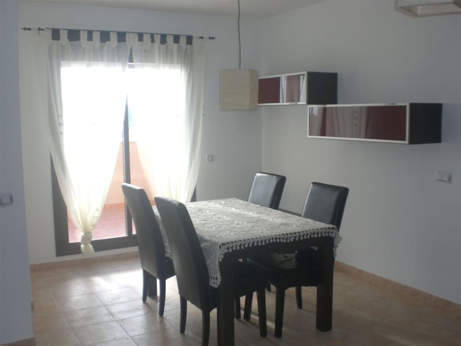 Dining room leading to balcony and steps up to the terrace.