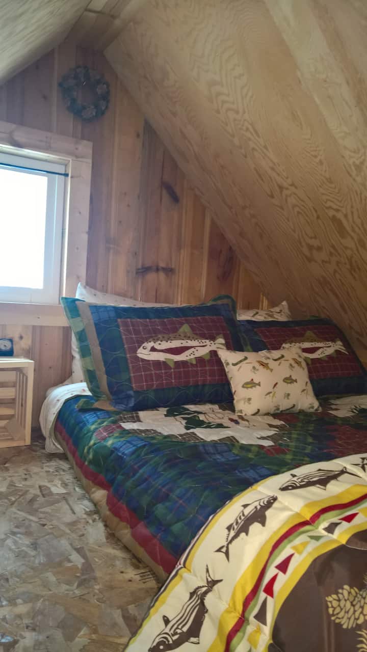 Climb the ladder up to the cozy sleeping loft with a full-sized mattress.