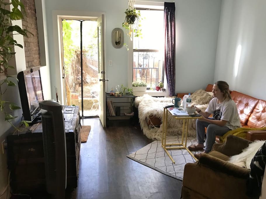 Living room with couch/TV and access to huge private backyard