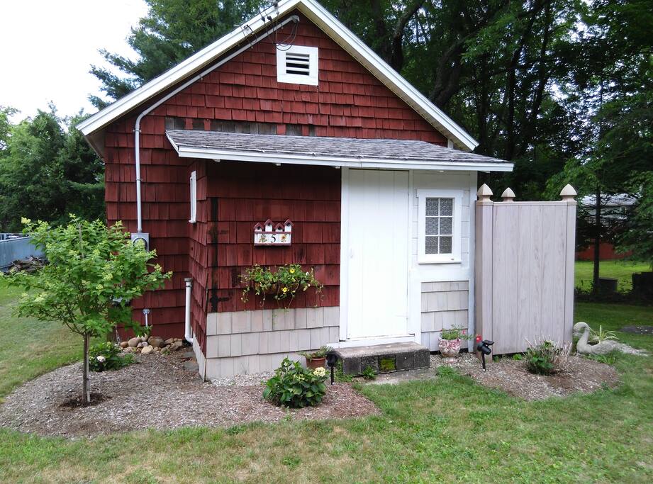 Front view of cottage and outdoor shower