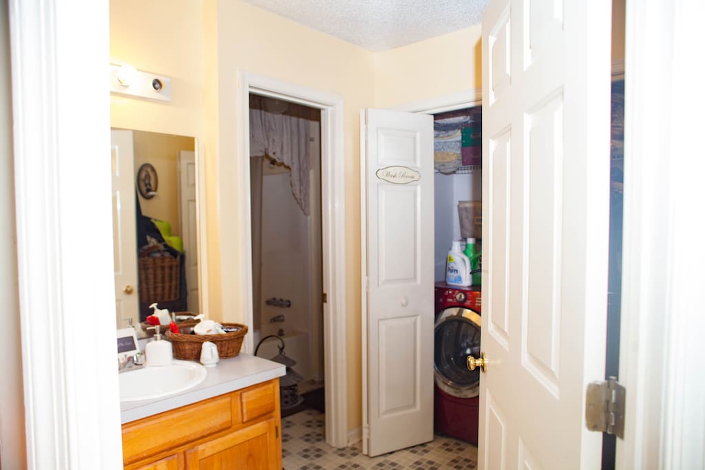 Guest bathroom with vanity, shower, tub