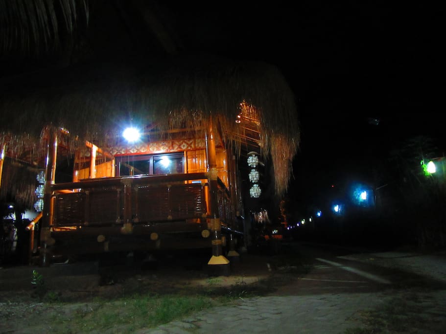 Bambu Uno (AirBnB Guesthouse) at night showing driveway lined up with LED upcycled inkbottles for lamps