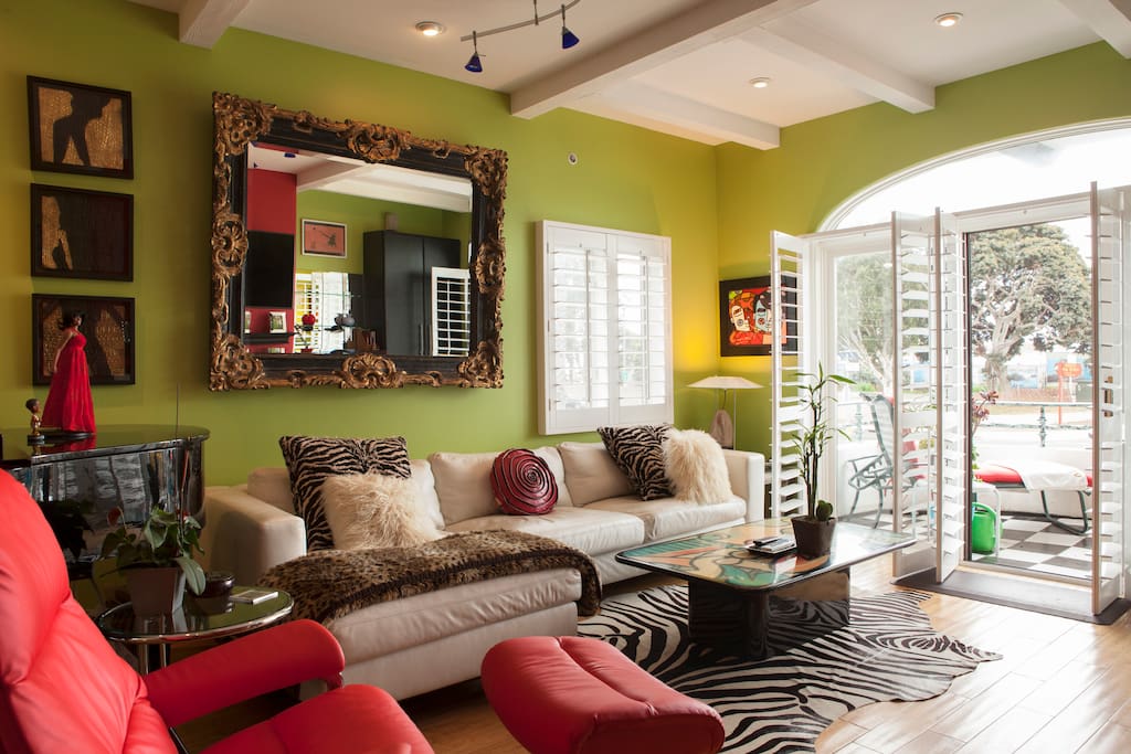 The living room with the fireplace and piano playing self with a orchestra