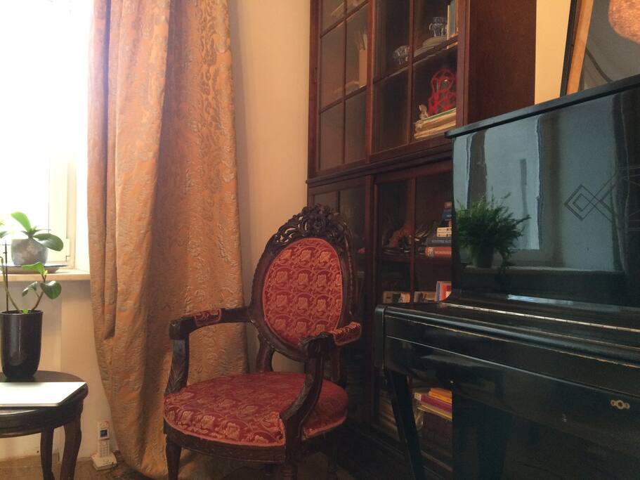 Guest bedroom. Antique chair and table set. You are welcome to play the piano!