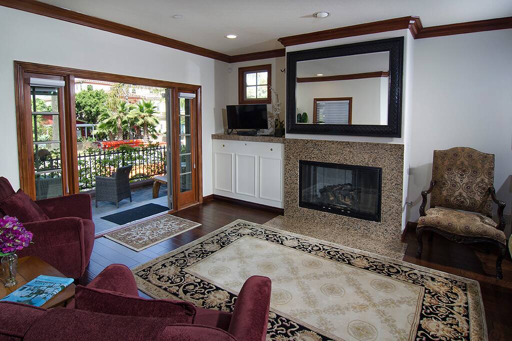 Living room with gas fireplace, french doors to patio.