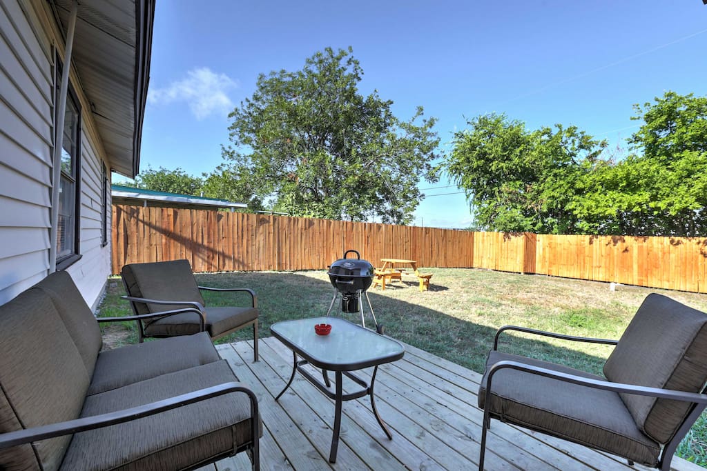 Relish in the large, fenced-in backyard that offers a deck, grill, patio furniture, and a picnic table.