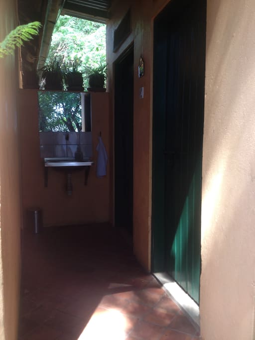 Toilet and shower behind the cabin, TP and towels provided for free