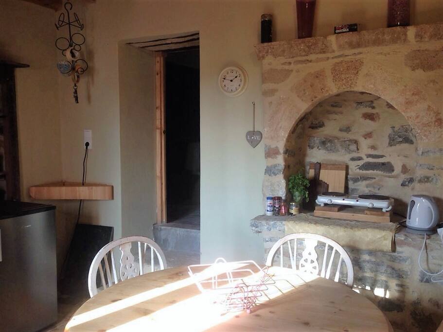 Viewing of ancient Greeck style Kitchen leading into the bathroom.