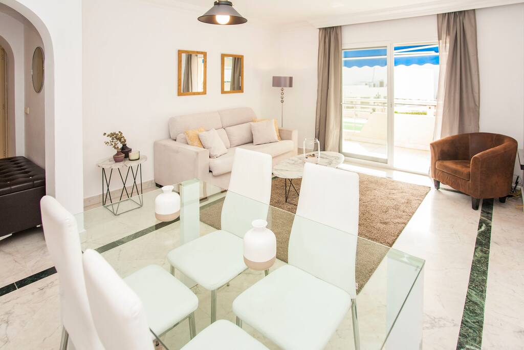 Living room with comfy sofa, dining area and TV with international channel