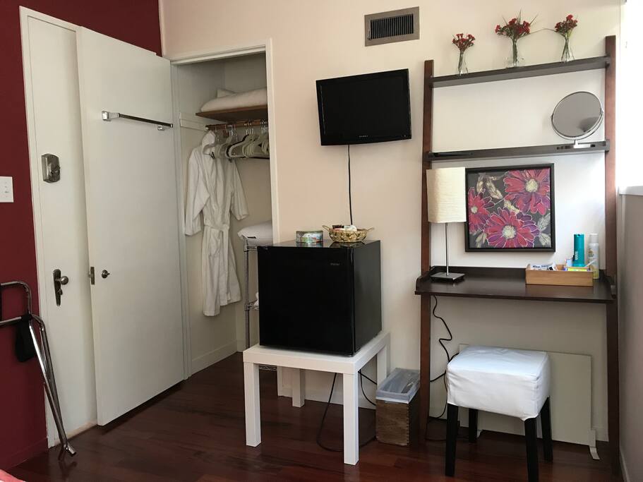 Desk area has a lamp, makeup mirror. TV has a DVD player and articulates.