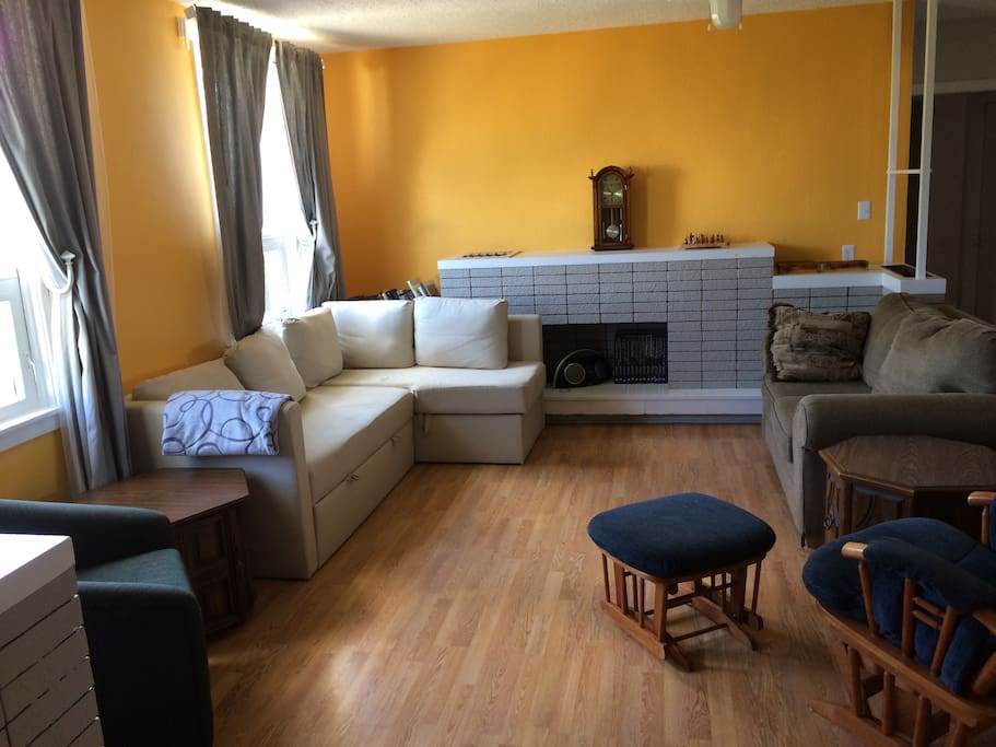 Living room. White couch can open into an extra queen size bed. Comfortable foamy and sheets for on top available.
