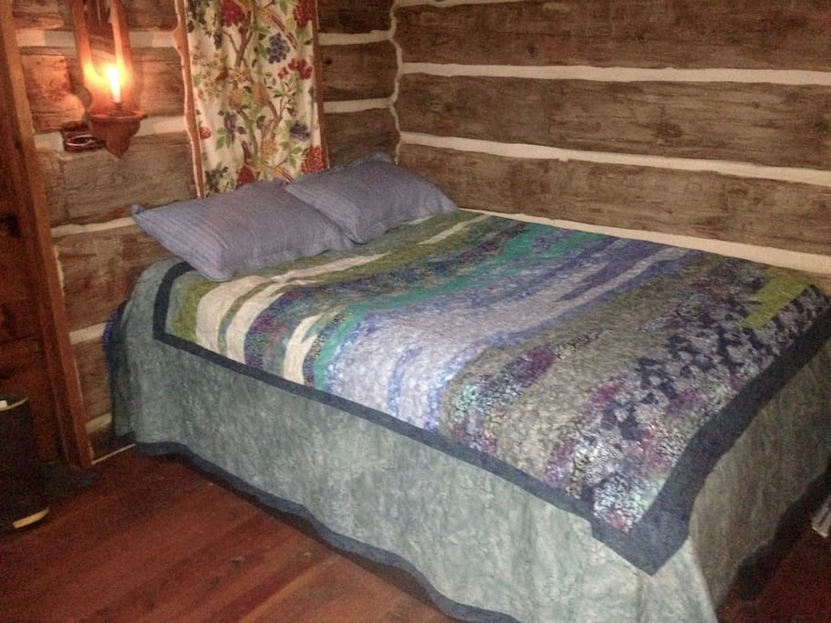 Luxury queen-sized bed with fluffy warm comforter and storage underneath.