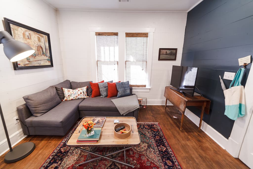 Eclectic decor set in a cozy living space with a pull-out sofa bed.