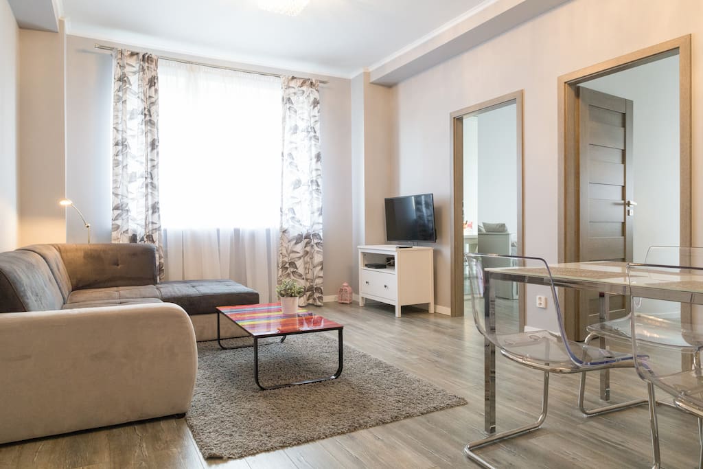 Relax in the spacious living room with a table, folding sofa bed and a TV