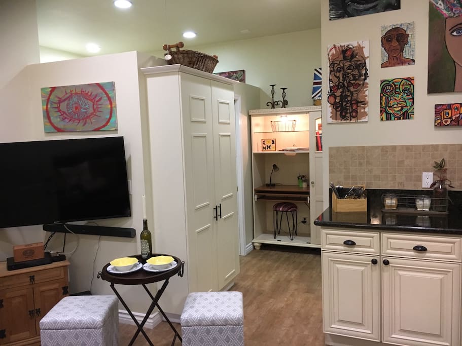 Main room with large screen TV, pantry and built in desk