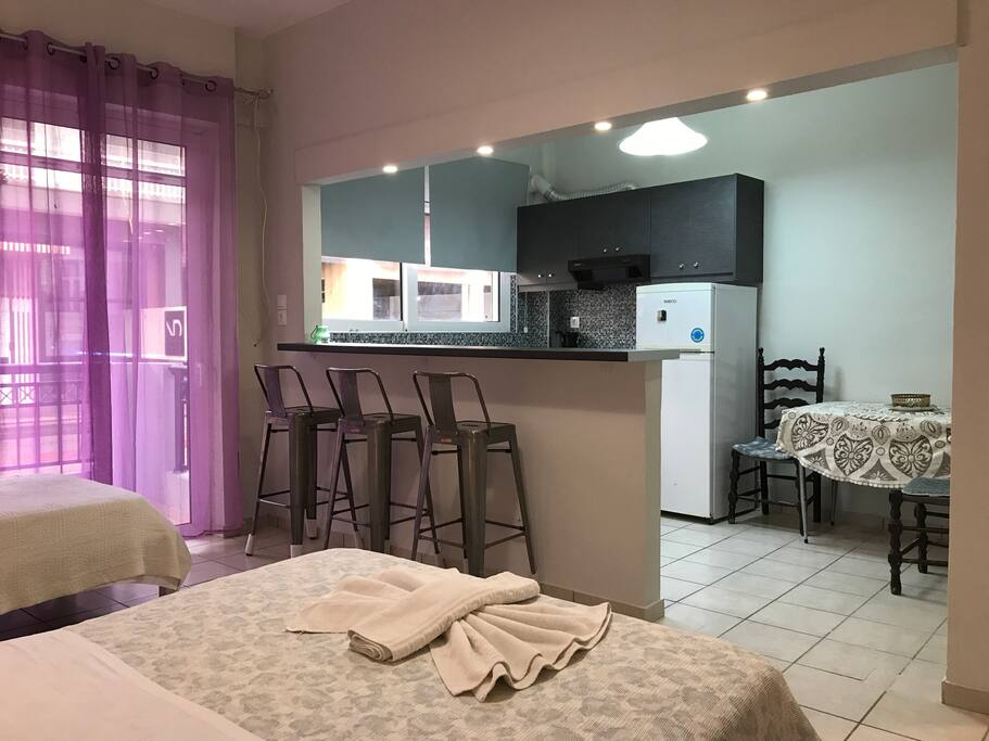 Kitchen, bar, balcony door looking the street