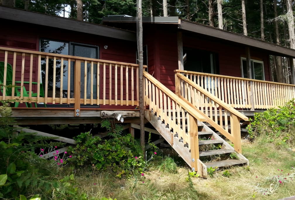 Three sliding doors connect both bedrooms and the living area to the deck.