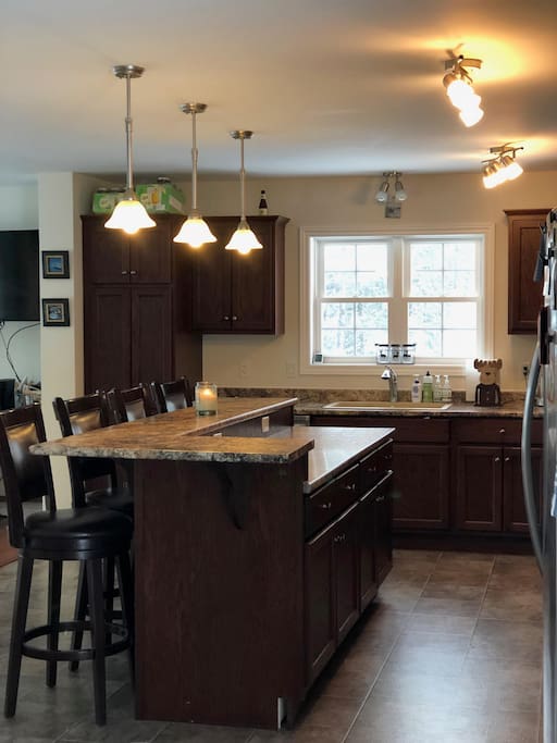 HUGE kitchen - open concept; features large island with bar seating for 4