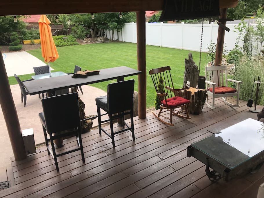 Covered porch overlooks patio and basketball court.