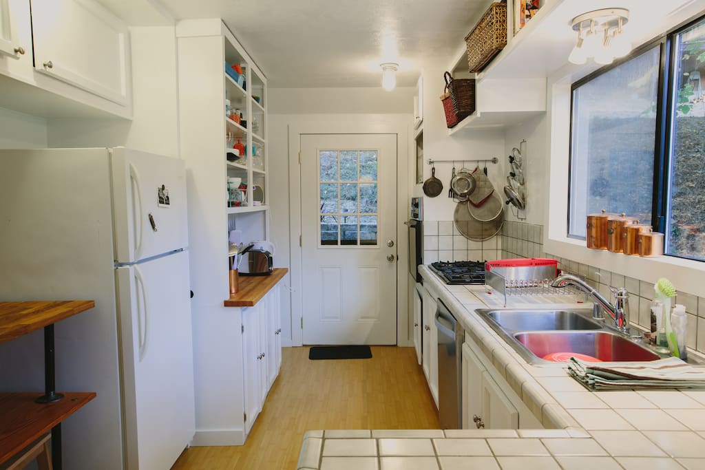 Full kitchen with dishes, all-you-can-consume-coffee and pantry essentials.