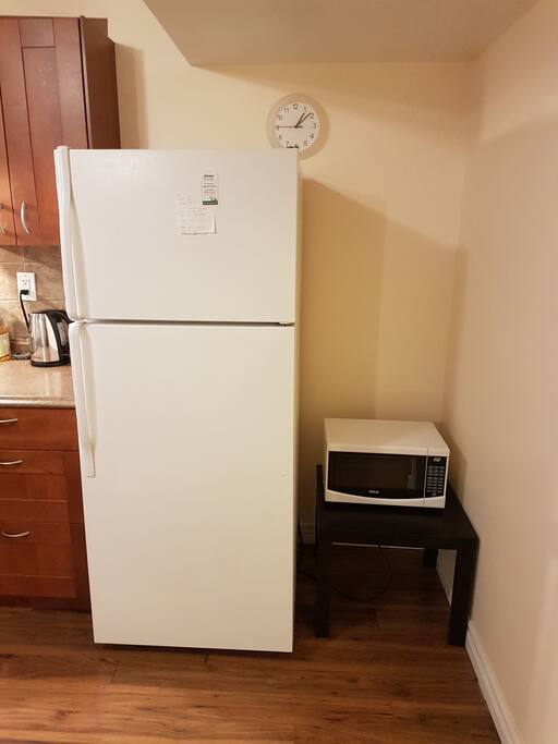 Fridge, Kettle and microwave next to the kitchen.