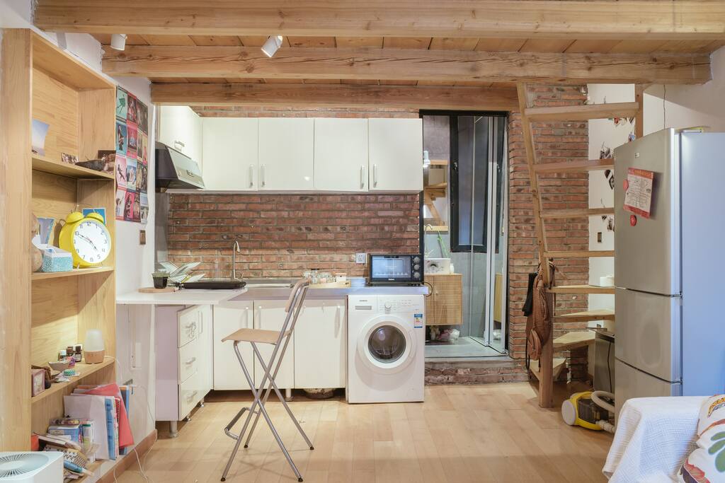 Kitchen open on the living room. At the back you can also see the bath room and the stairs to go to the mezzanine where is the bed