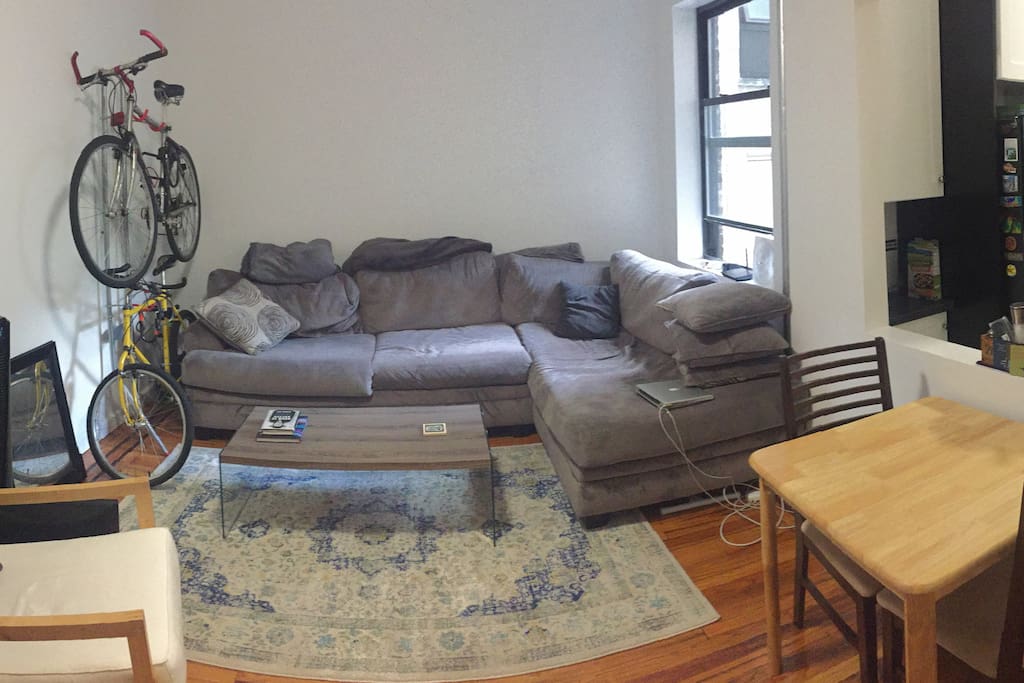 Large, relaxed living room with very comfy couch, dining area, video and music streaming