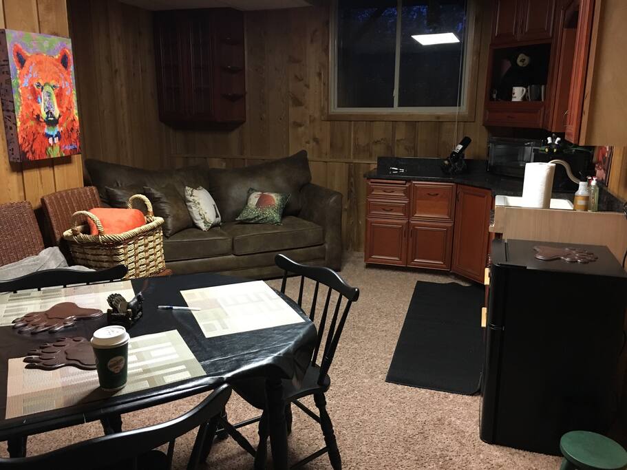 A nice space to stay-a kitchen with a BEAR-y cozy feel! Lots of storage!!! Private. There's a new queen sofa-sleeper, a dinner table for 4+ and more! A coffee maker (and coffee), smaller refrigerator & freezer, microwave, extra large counter oven and burners are ready for your cooking pleasure. Dishes and cookware included. Bring your favorite food and drinks, make yourself at home and enjoy! There is complimentary beer, wine and goodies for you to enjoy.