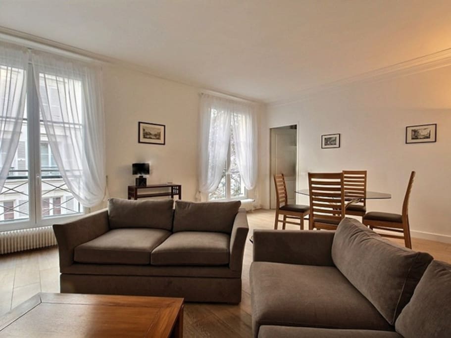 Living
The 35 square meters living room has 2 double glazed windows facing courtyard . It is equipped with : dining table for 4 people, 2 sofa, coffee table, TV, armchair, built-in shelves, decorative fireplace, hard wood floor.