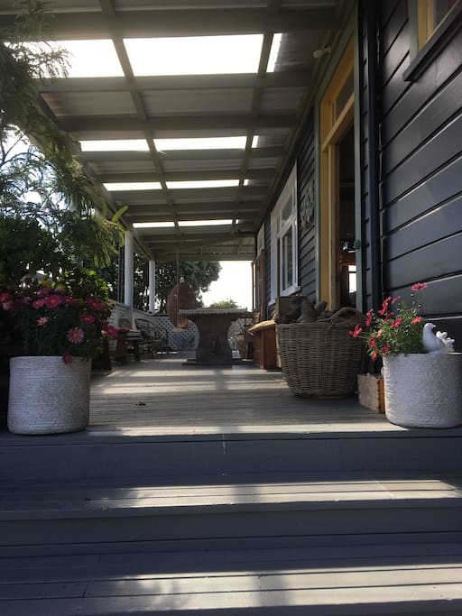 The sweeping verandah with steps up to the front door