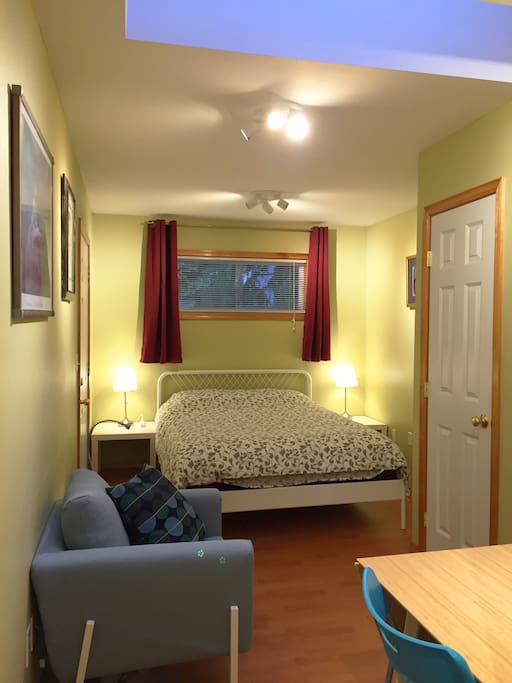 Comfy chair and queen bed.