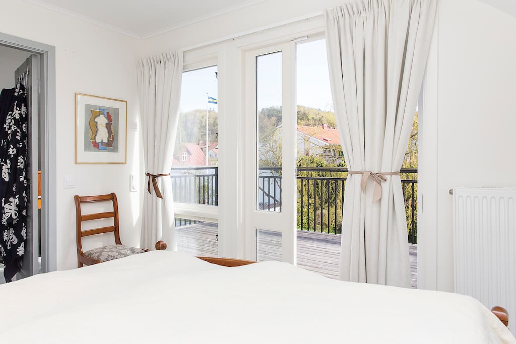 Sunny master bedroom with balcony overlooking the garden.