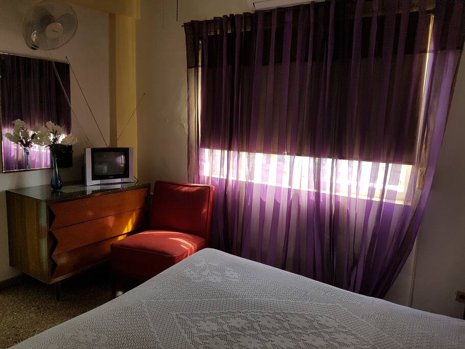 Hotel like room featuring a beautiful one piece bed set and modern light fixtures