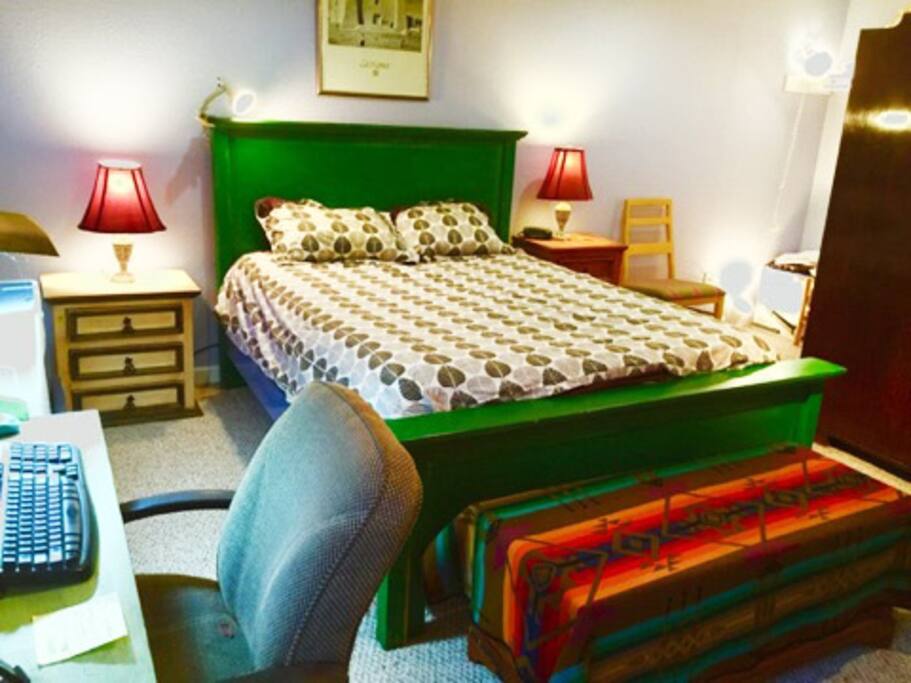 Bed room has comfortable queen bed and lots of comforters, blankets and different pillows.