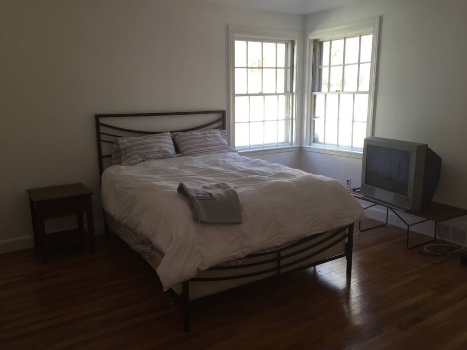 Main bedroom on the first floor with queen size bed, two closets and wood floors