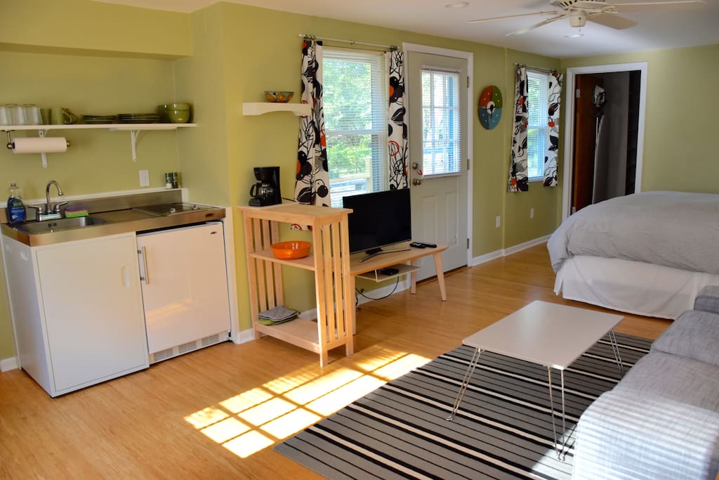 Kitchenette to left, flat screen smart tv, exit to private deck.