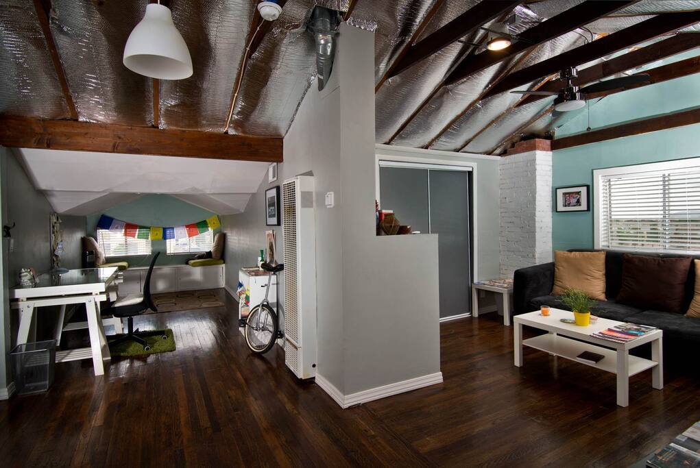 View of the loft area with couch, work area & reading nook. Full privacy.