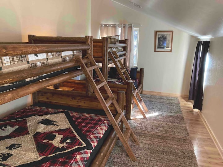 Upstairs room with two twin over queen bunk beds. Sleeps 6 total perfect for family, kids, or friends !