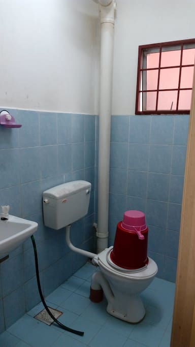 A toilet outside the bedrooms