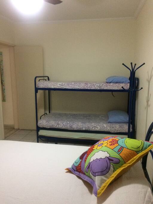 Quarto com ar condicionado, cama de casal e treliche