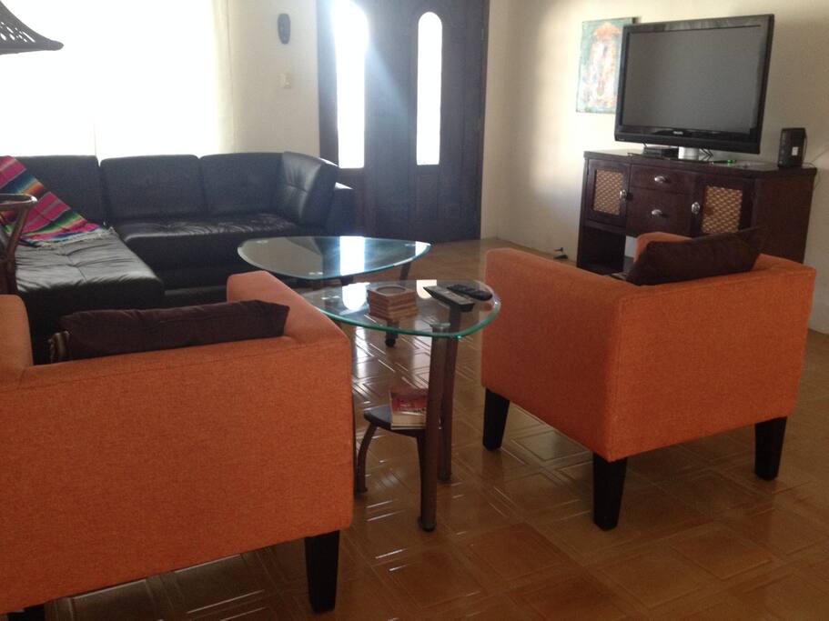 Comfortable living room with large flat screen TV.
