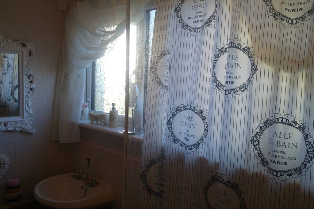Bathroom with bath and rain shower.
