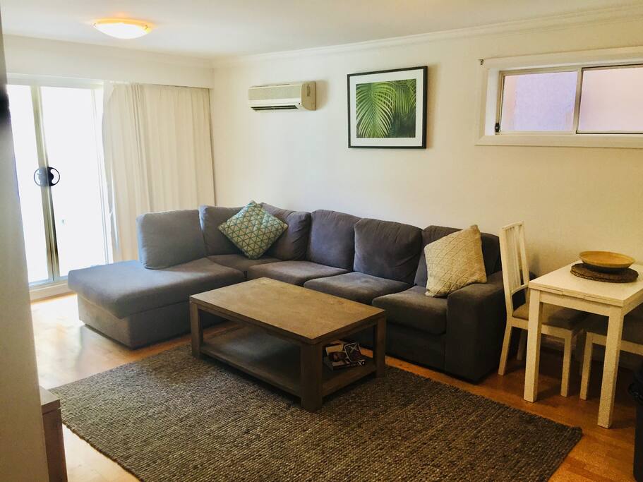 Great open plan living area with modern decor and balcony . Stones throw away from Coogee beach .