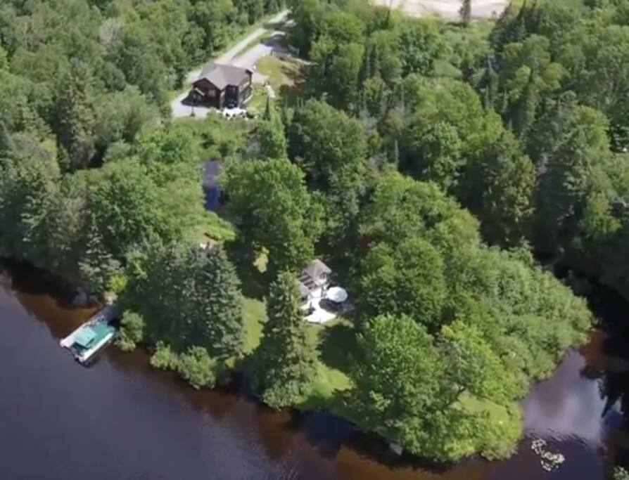 Aerial view of property. You can see the house, entertainment area, 250 feet of waterfront and dock.