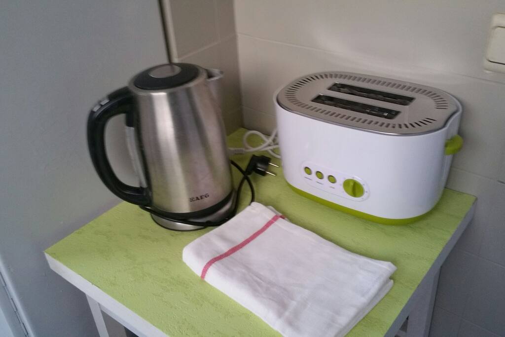 Kettle and toaster available in kitchen with microwave
