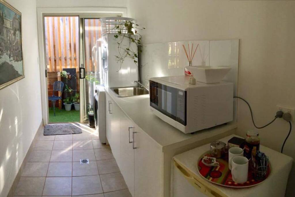 Private entrance through small Kitchen with Washer and dryer.