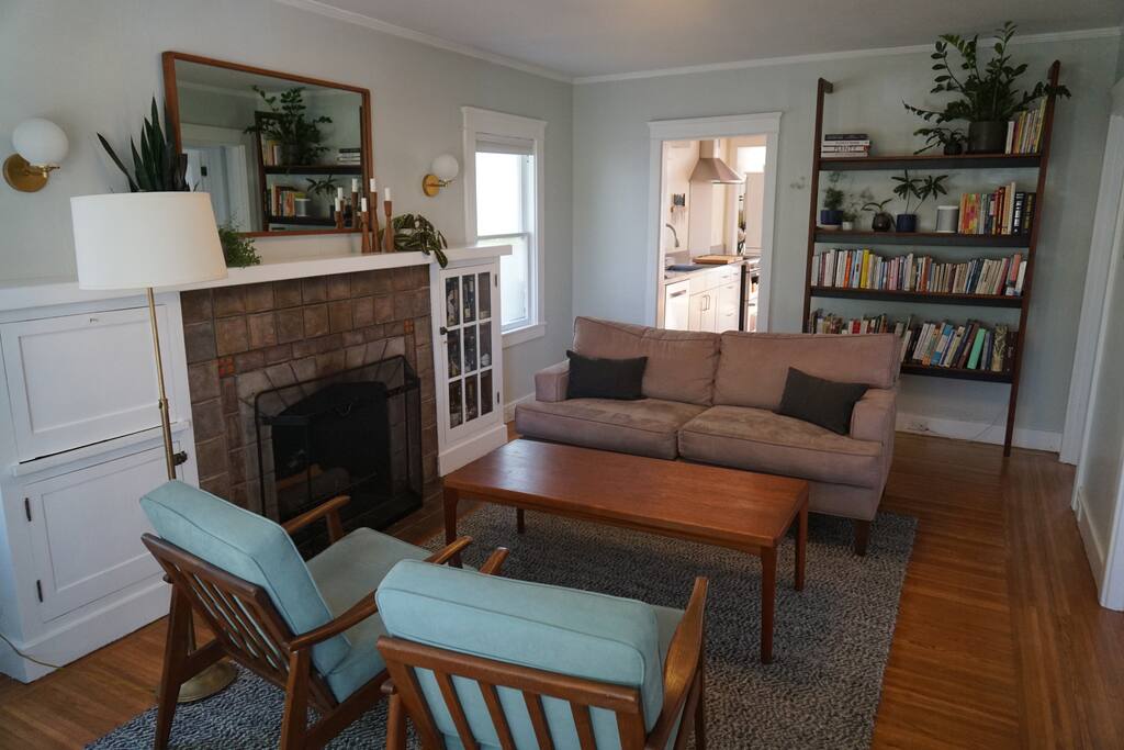 Living room: This is the view when you step in the front door. You'll have a comfy couch, two mid-century arm chairs and a large bookcase full of gems to browse.